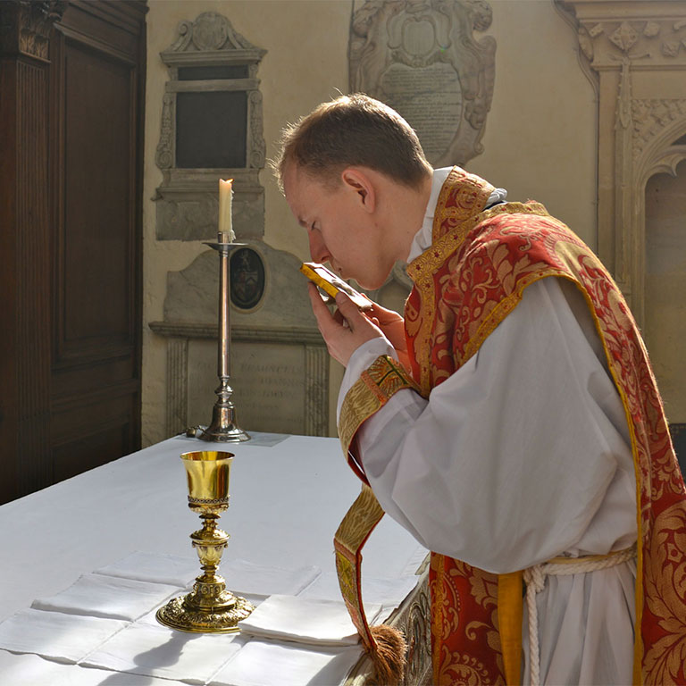 Priest kisses the pax